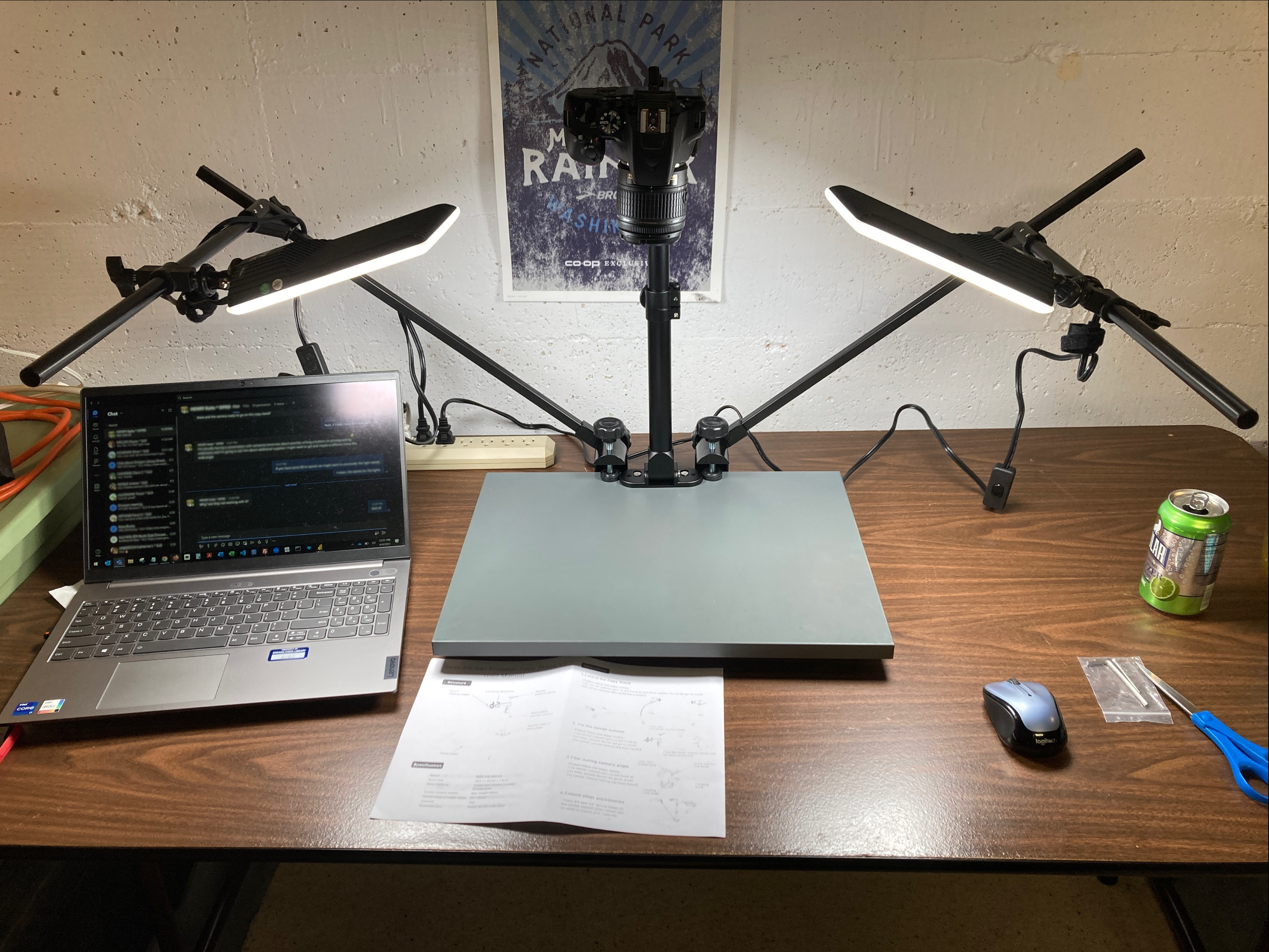 A camera stand overhead digitization station with lights and a laptop.